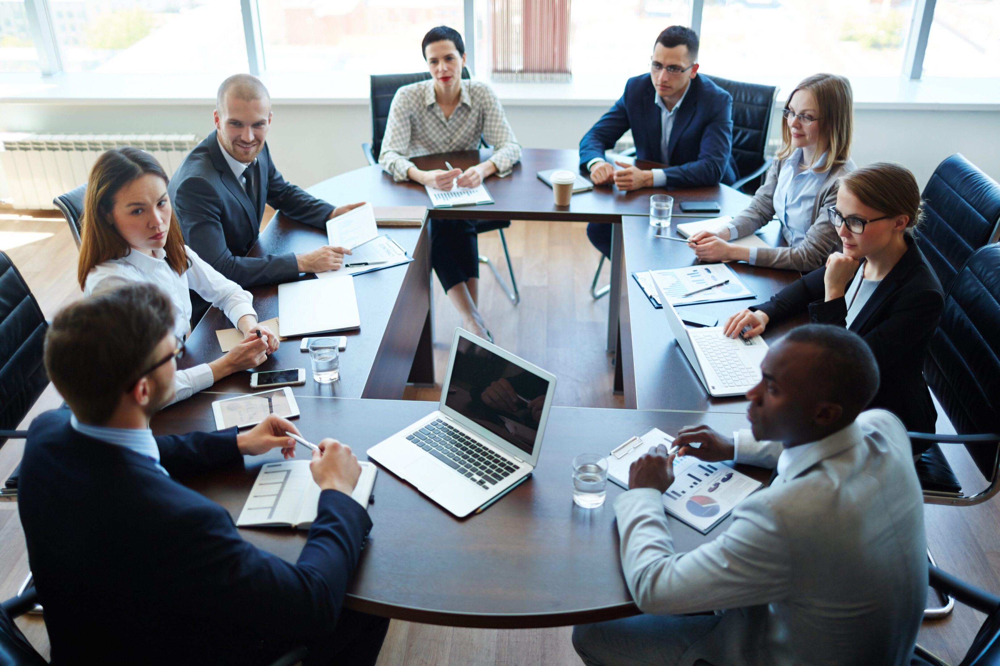 Diverse professionals collaborating around a conference table in a modern office.
