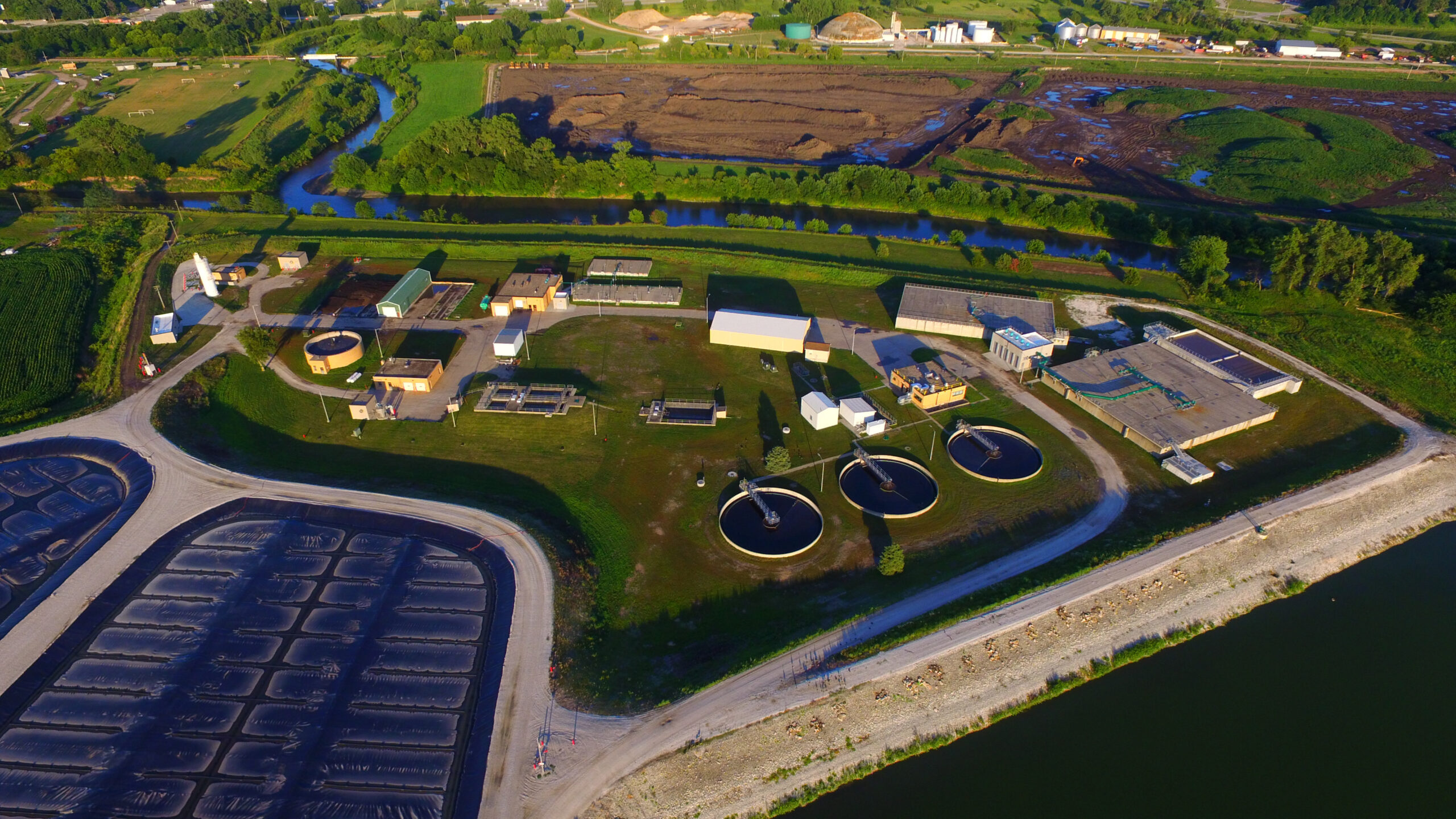 DCIM101MEDIADJI_0216.JPG Aerial view of a water treatment facility with various tanks and structures.